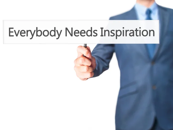 Everybody Needs Inspiration - Businessman hand holding sign — Stock Photo, Image