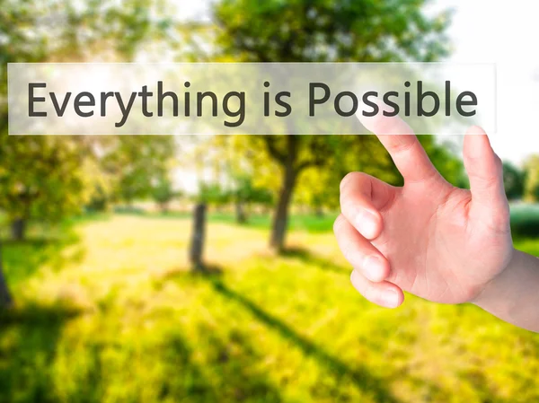 Everything is Possible - Hand pressing a button on blurred backg — Stock Photo, Image