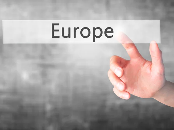 Europe - Hand pressing a button on blurred background concept on — Stock Photo, Image