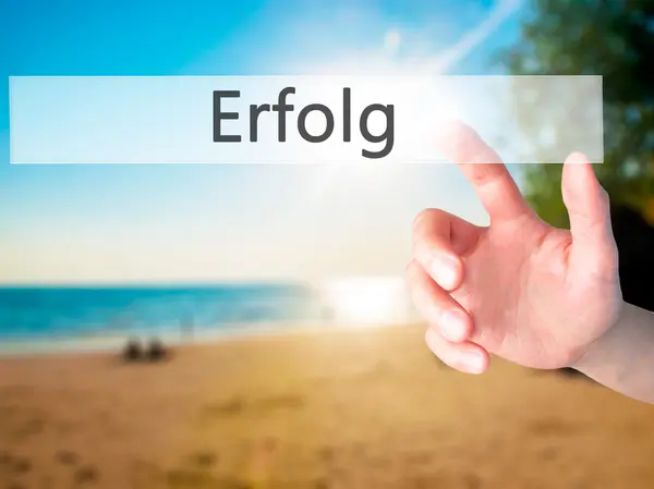 Erfolg (Success) - Hand pressing a button on blurred background — Stock Photo, Image