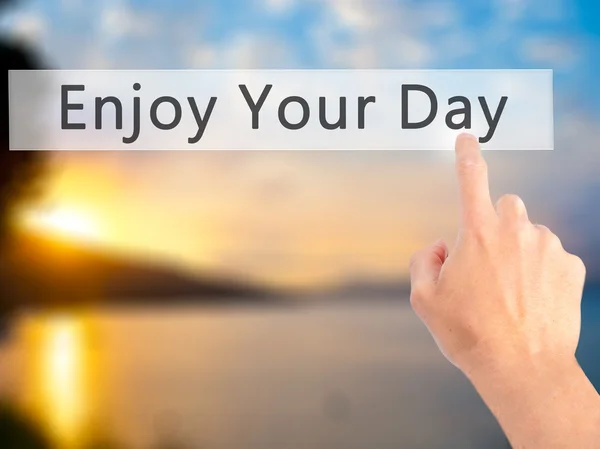 Enjoy Your Day - Hand pressing a button on blurred background co — Stock Photo, Image