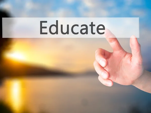 Educate - Hand pressing a button on blurred background concept o — Stock Photo, Image