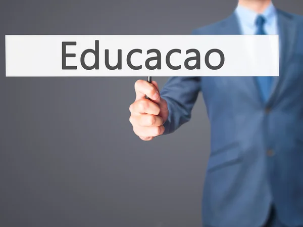 Educaco (Bildung auf portugiesisch) - Geschäftsmann Hand in Hand sig — Stockfoto