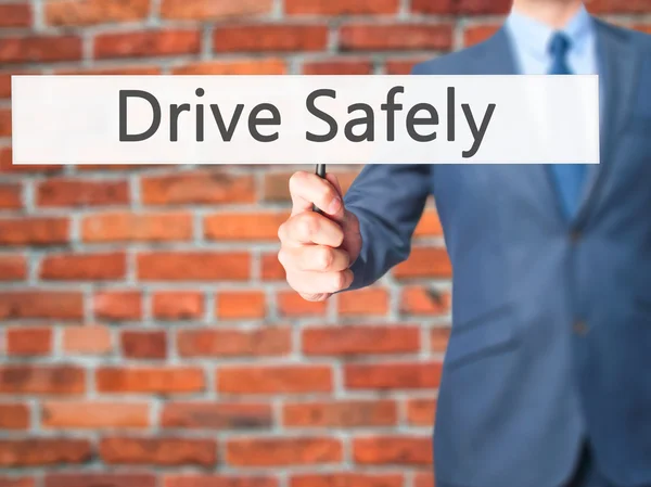 Conduce con seguridad - Empresario mano sosteniendo el cartel —  Fotos de Stock