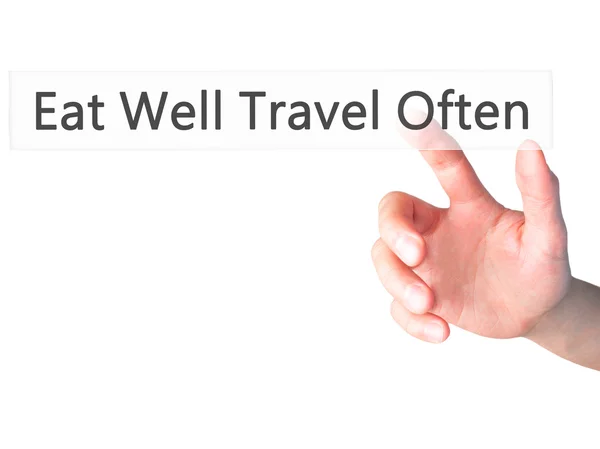 Eat Well Travel Often - Hand pressing a button on blurred backgr — Stock Photo, Image