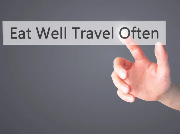 Eat Well Travel Often - Hand pressing a button on blurred backgr — Stock Photo, Image