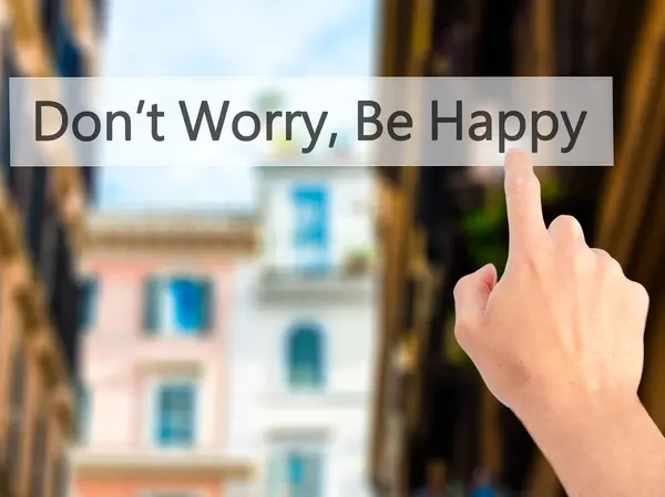 Don't Worry, Be Happy - Hand pressing a button on blurred backgr — Stock Photo, Image