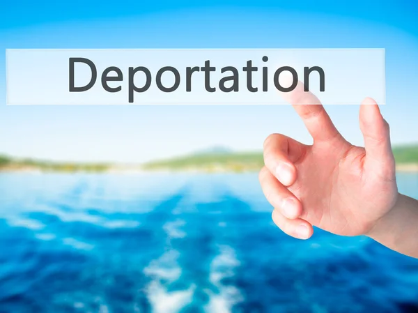 Deportation - Hand pressing a button on blurred background conce — Stock Photo, Image