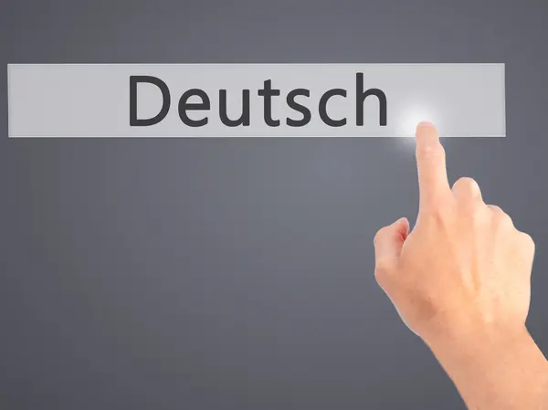 Deutsh (German in German) - Hand pressing a button on blurred ba — Stock Photo, Image