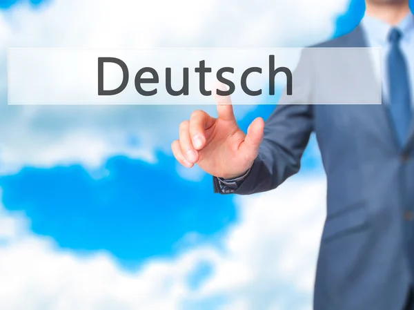 Deutsh (немецкий по-немецки) - Businessman вручную нажимает на кнопку t — стоковое фото