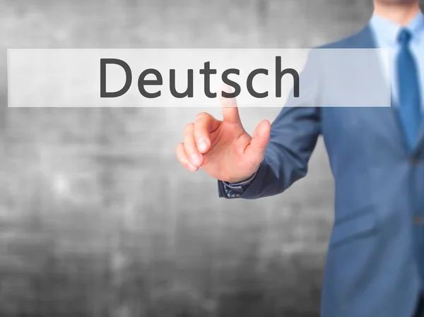Deutsh (német, német nyelven) - üzletember kézzel nyomja a gombot a t — Stock Fotó