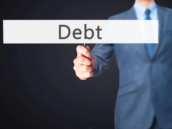 Debt - Businessman hand holding sign — Stock Photo, Image