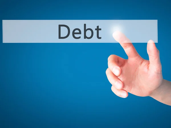 Dívida - Mão pressionando um botão no conceito de fundo borrado em v — Fotografia de Stock