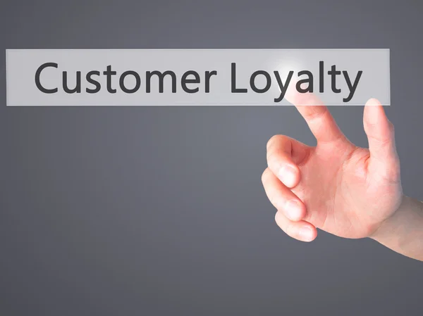 Customer Loyalty - Hand pressing a button on blurred background — Stock Photo, Image