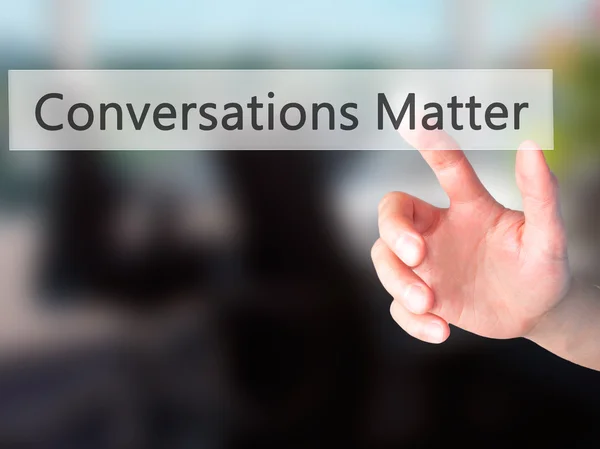 Conversations Matter - Hand pressing a button on blurred backgro — Stock Photo, Image