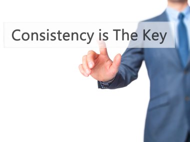 Consistency is The Key - Businessman hand touch  button on virtu clipart