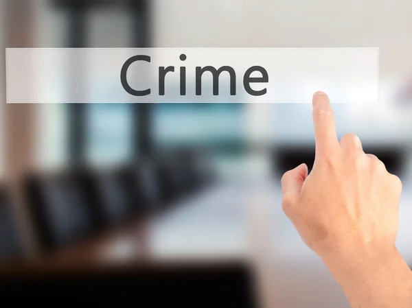 Crime - Hand pressing a button on blurred background concept on — Stock Photo, Image