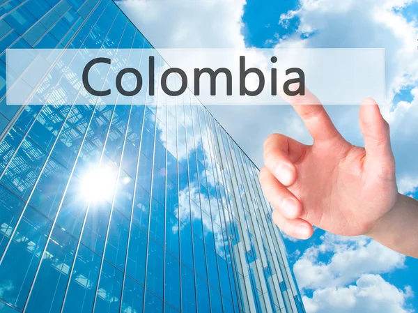 Colombia - Mano presionando un botón sobre el concepto de fondo borroso — Foto de Stock