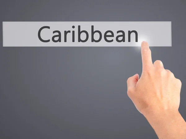 Caribe - Mano presionando un botón sobre el concepto de fondo borroso — Foto de Stock
