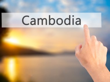 Kamboçya - arka plan bulanık kavramı üzerinde bir düğmeye basarak el 