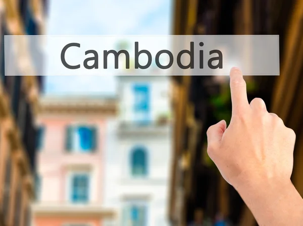 Cambogia - Mano premendo un pulsante sul concetto di sfondo sfocato — Foto Stock