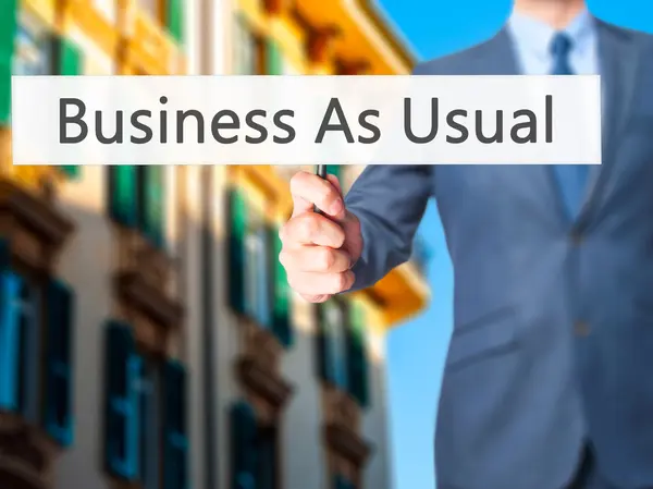 Business As Usual - zakenman teken tonen — Stockfoto