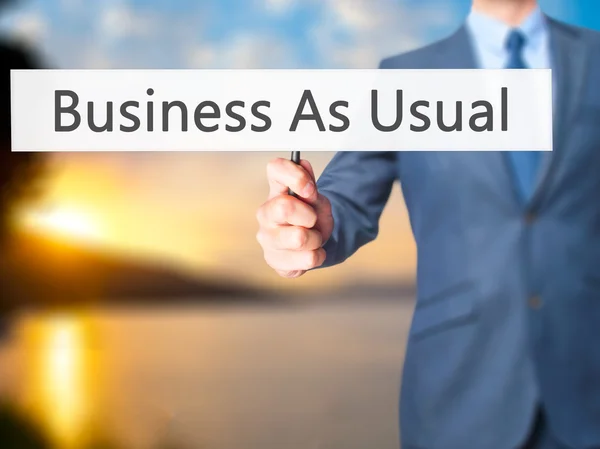Biznes jak zwykle - człowiek biznesu Wyświetlono znak — Zdjęcie stockowe