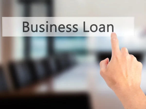 Business Loan - Hand pressing a button on blurred background con — Stock Photo, Image