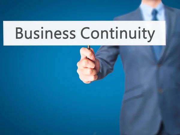 Business Continuity - Business man showing sign — Stock Photo, Image