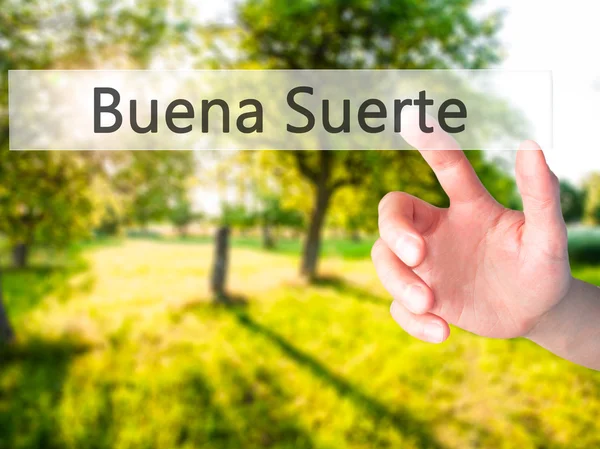 Buena suerte (viel Glück auf Spanisch) - Hand drückt einen Knopf auf — Stockfoto