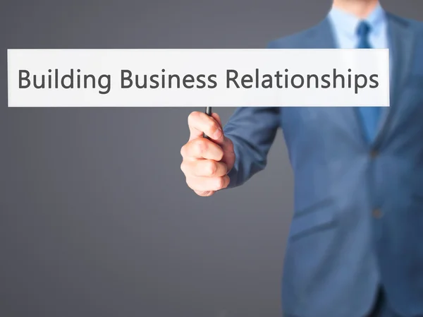 Costruire relazioni d'affari - Business man holding sign — Foto Stock