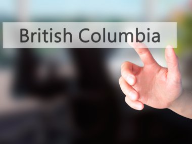 British Columbia - bulanık arka plan üzerinde bir düğmeye basarak el 