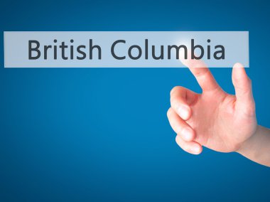 British Columbia - bulanık arka plan üzerinde bir düğmeye basarak el 