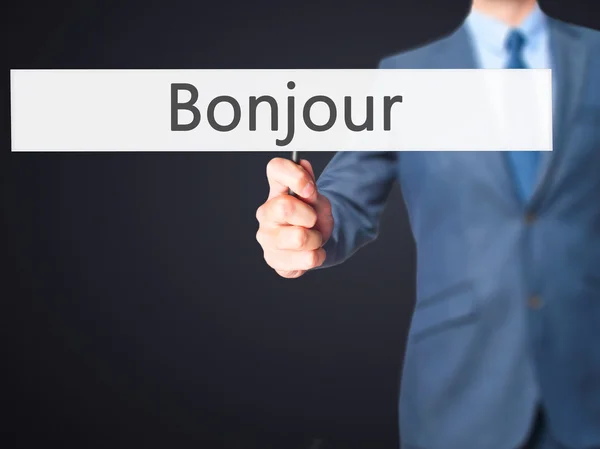 Bonjour (Good Morning in French) - Businessman hand holding sign — Stock Photo, Image