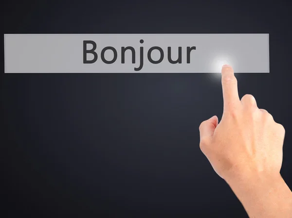 Bonjour (Good Morning in French) - Hand pressing a button on blu — Stock Photo, Image