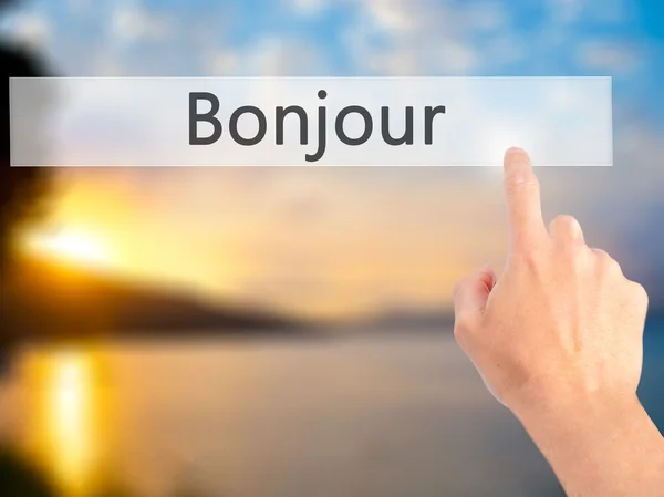 ボンジュール(フランス語でおはようございます) - ブルーのボタンを押す手 — ストック写真
