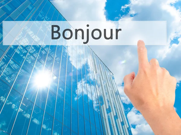 Bonjour (Good Morning in French) - Hand pressing a button on blu — Stock Photo, Image