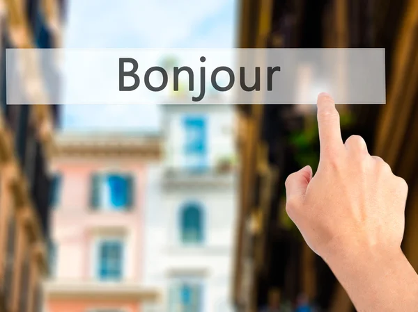 Bonjour (Buongiorno in francese) - Premere a mano un pulsante su blu — Foto Stock