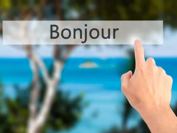 Bonjour (Доброе утро на французском языке) - Ручное нажатие кнопки на blu — стоковое фото