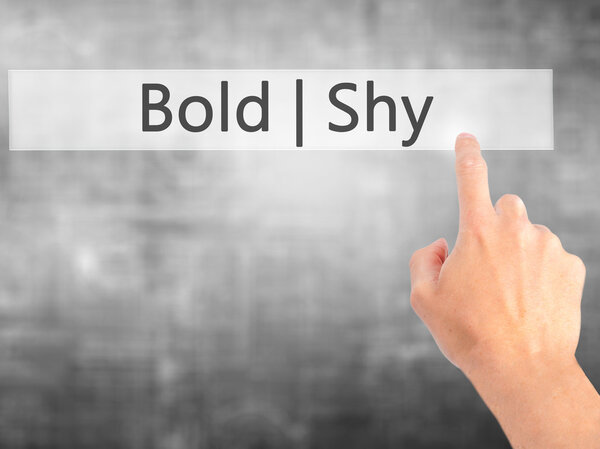 Bold Shy - Hand pressing a button on blurred background concept 