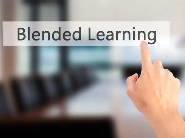 Blended Learning - Hand pressing a button on blurred background — Stock Photo, Image