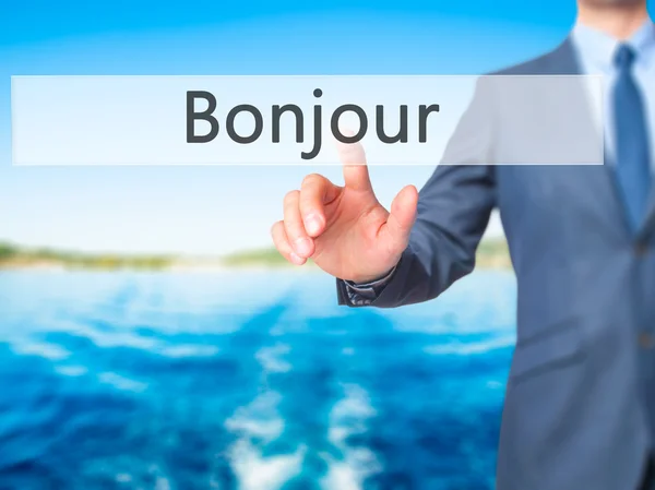 Bonjour (Доброе утро на французском языке) - Businessman hand touch butto — стоковое фото