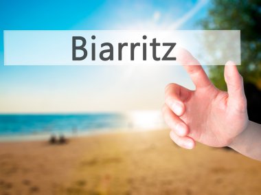 Biarritz - arka plan bulanık kavramı üzerinde bir düğmeye basarak el 