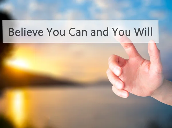 Believe You Can and You Will - Hand pressing a button on blurred — Stockfoto