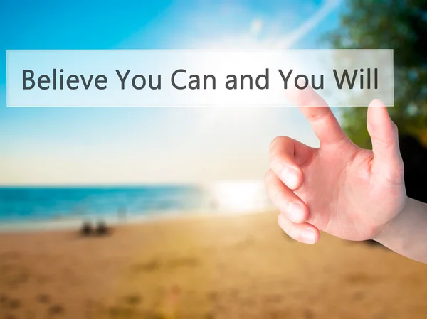 Believe You Can and You Will - Hand pressing a button on blurred — Stockfoto