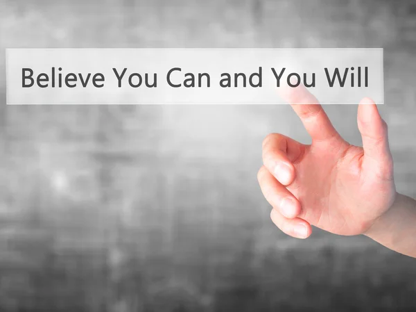 Believe You Can and You Will - Hand pressing a button on blurred — Stockfoto