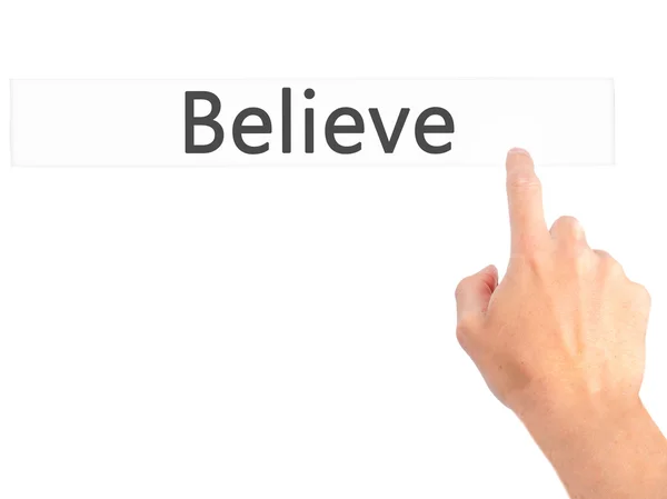 Believe - Hand pressing a button on blurred background concept o — Stock Photo, Image