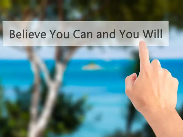 Believe You Can and You Will - Hand pressing a button on blurred — Stockfoto