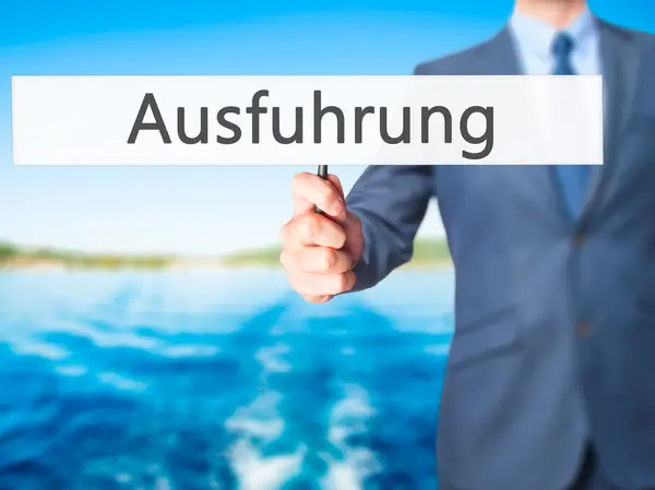 Ausfuhrung (Execução em alemão) - Homem de negócios mostrando sinal — Fotografia de Stock