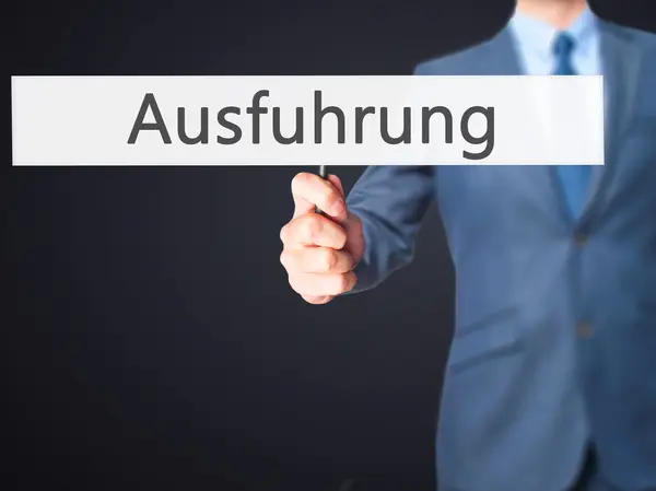 Ausfuhrung (avrättning på tyska)-Business man visar Sign — Stockfoto